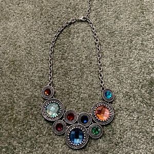 Multi colored jeweled necklace with silver metal.